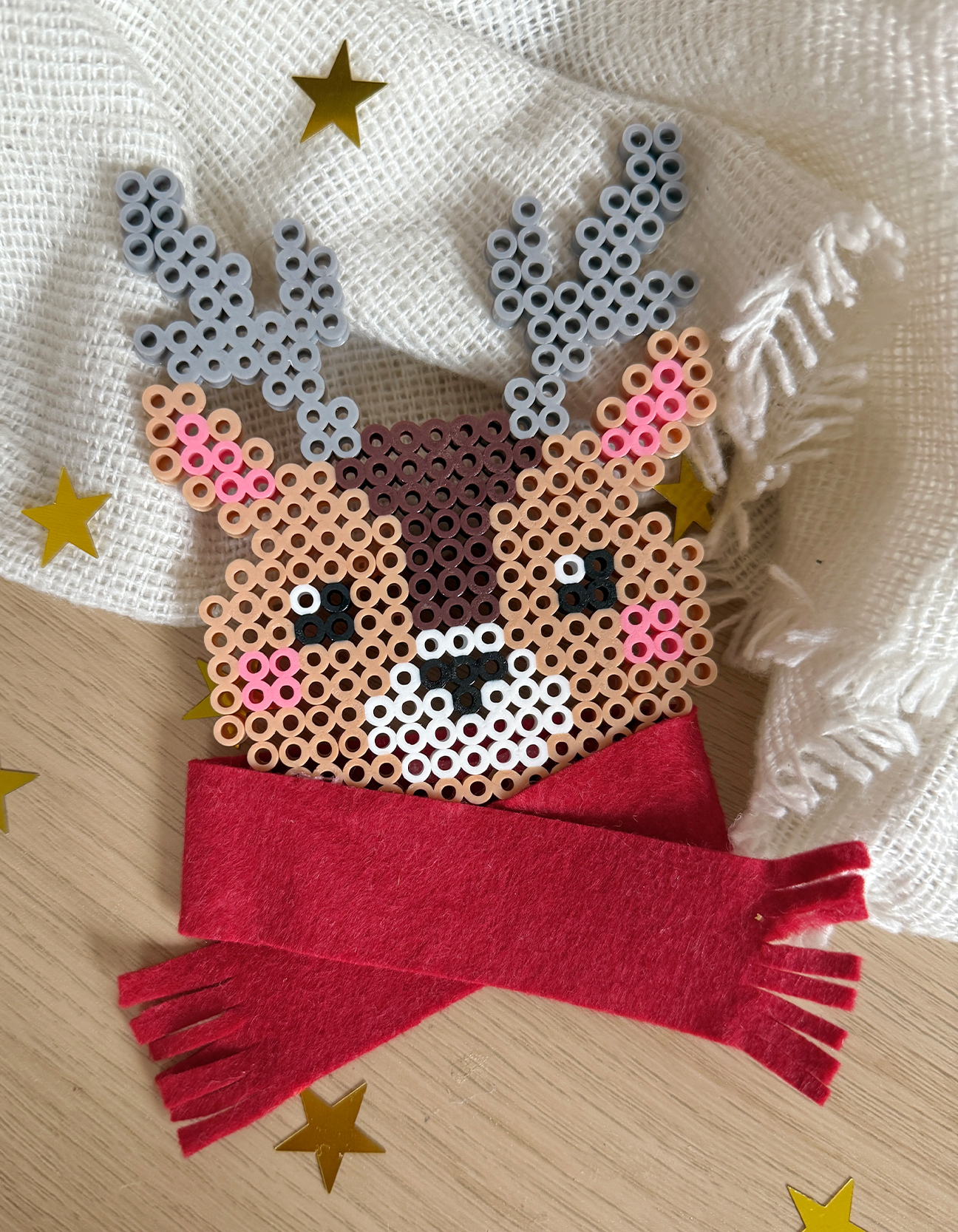 Finished reindeer fuse bead ornament with a red felt scarf — a charming handmade Christmas craft for your tree.