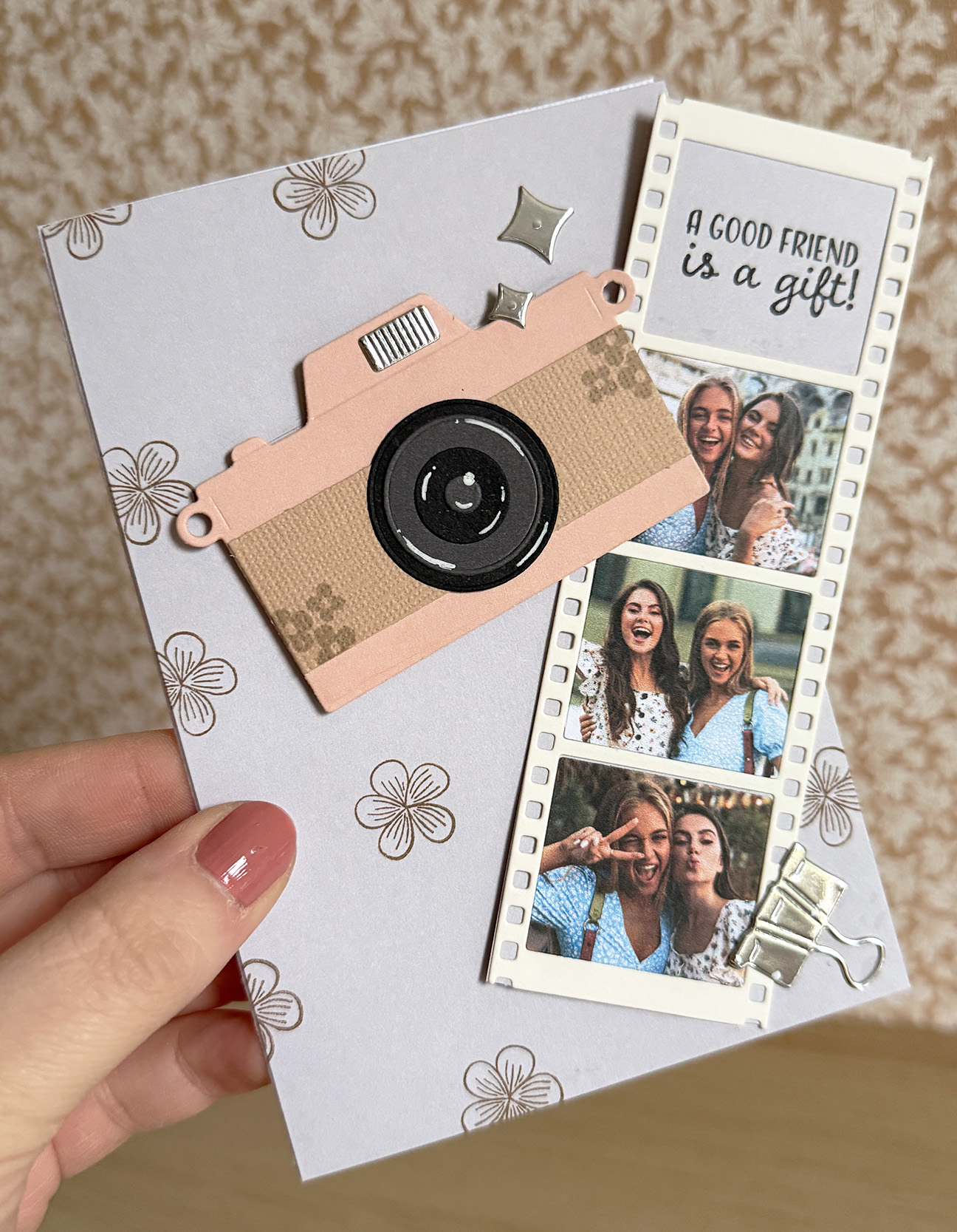 Handmade greeting card with a paper camera and a pull-out photo strip.