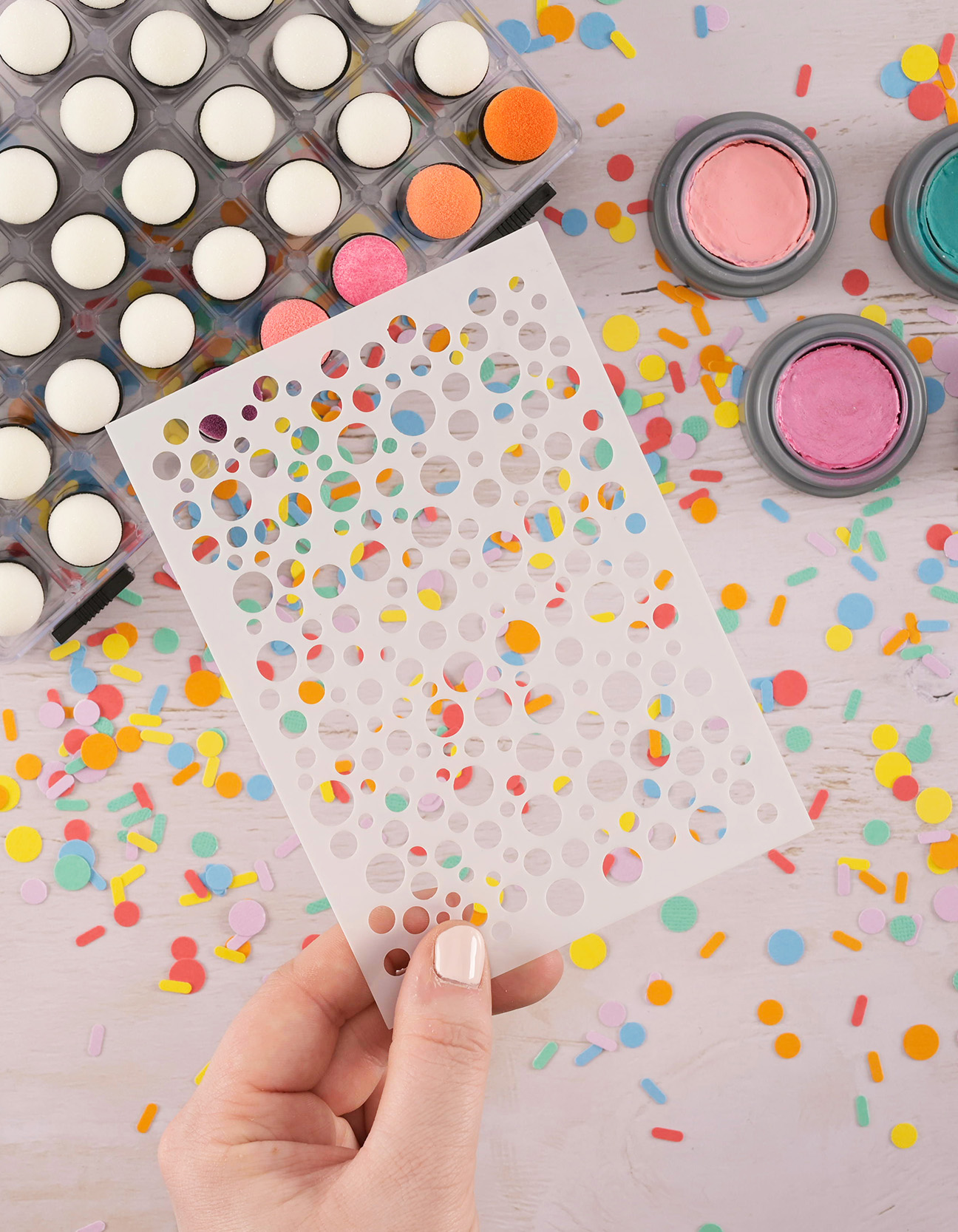 Stencil and face paint with daubers on the table for kids’ stencil face painting