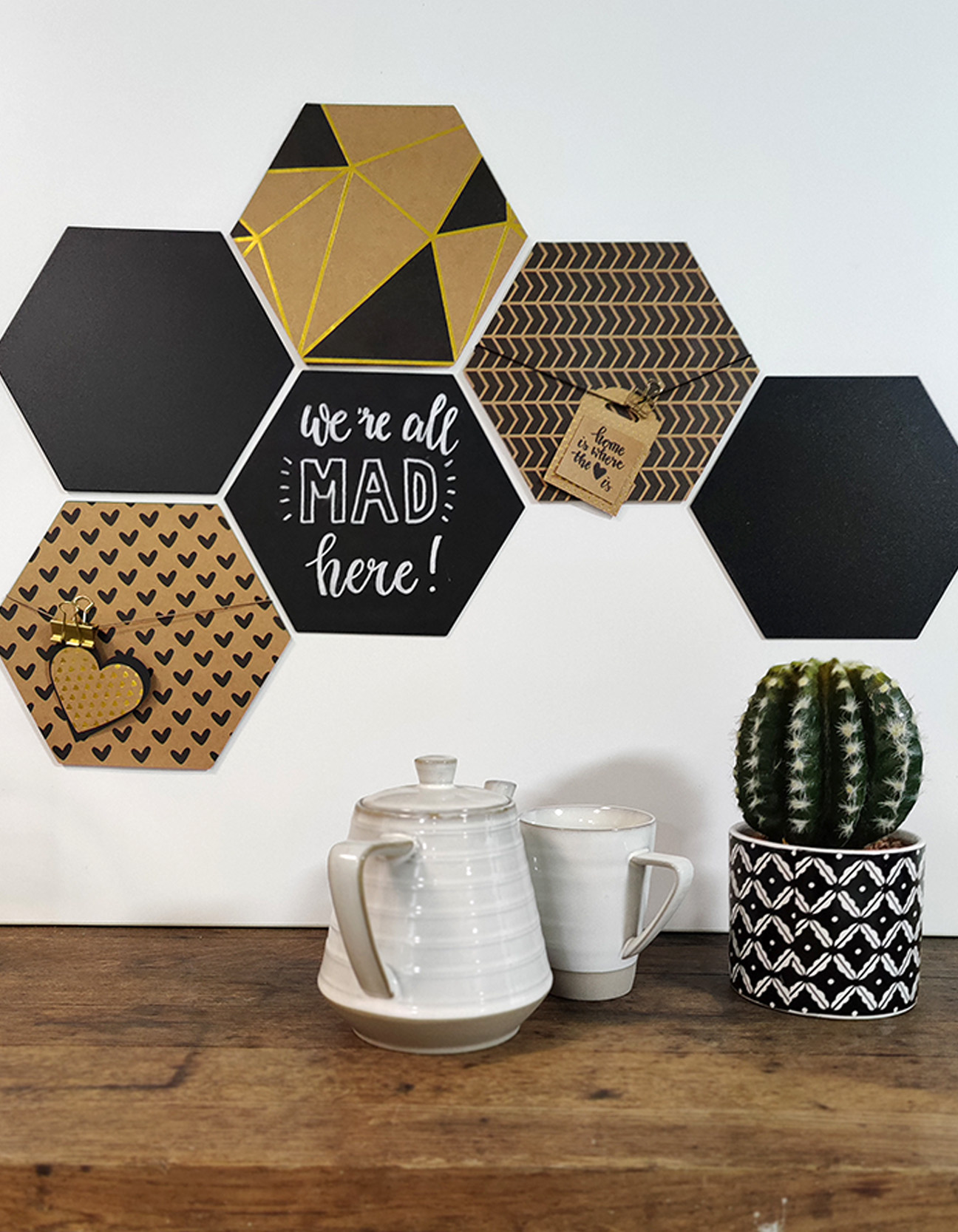 Handmade hexagon wall decoration with kraft paper, chalkboard panels, tags and a modern home interior display.