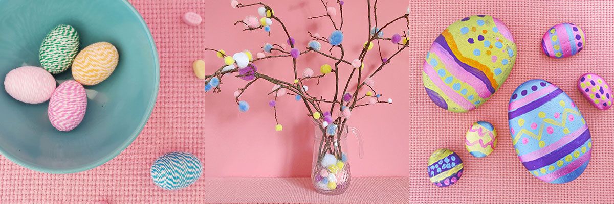 Handgemachte Osterdeko mit umwickelten Eiern, Pompon-Osterzweigen und bemalten Steinen