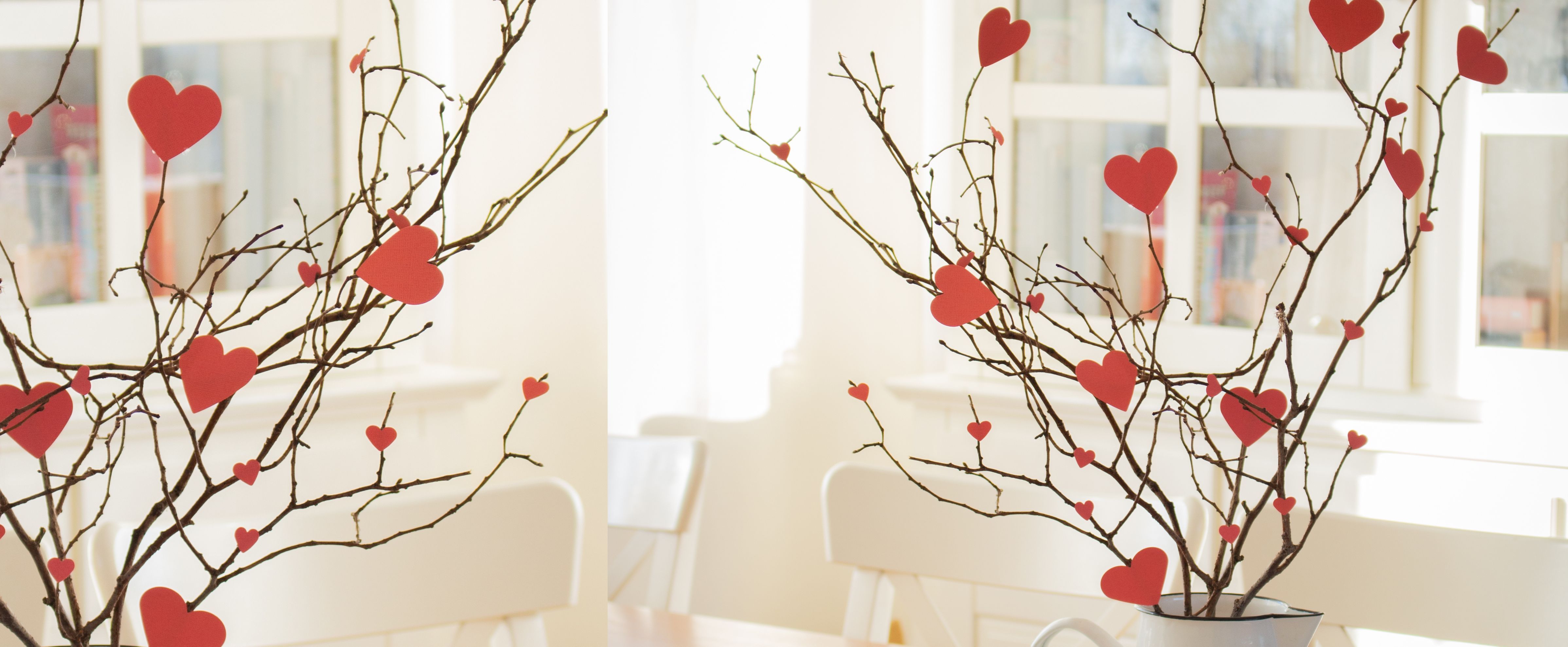 Branches decorated with red paper hearts arranged in a vase, creating a romantic heart-themed display.