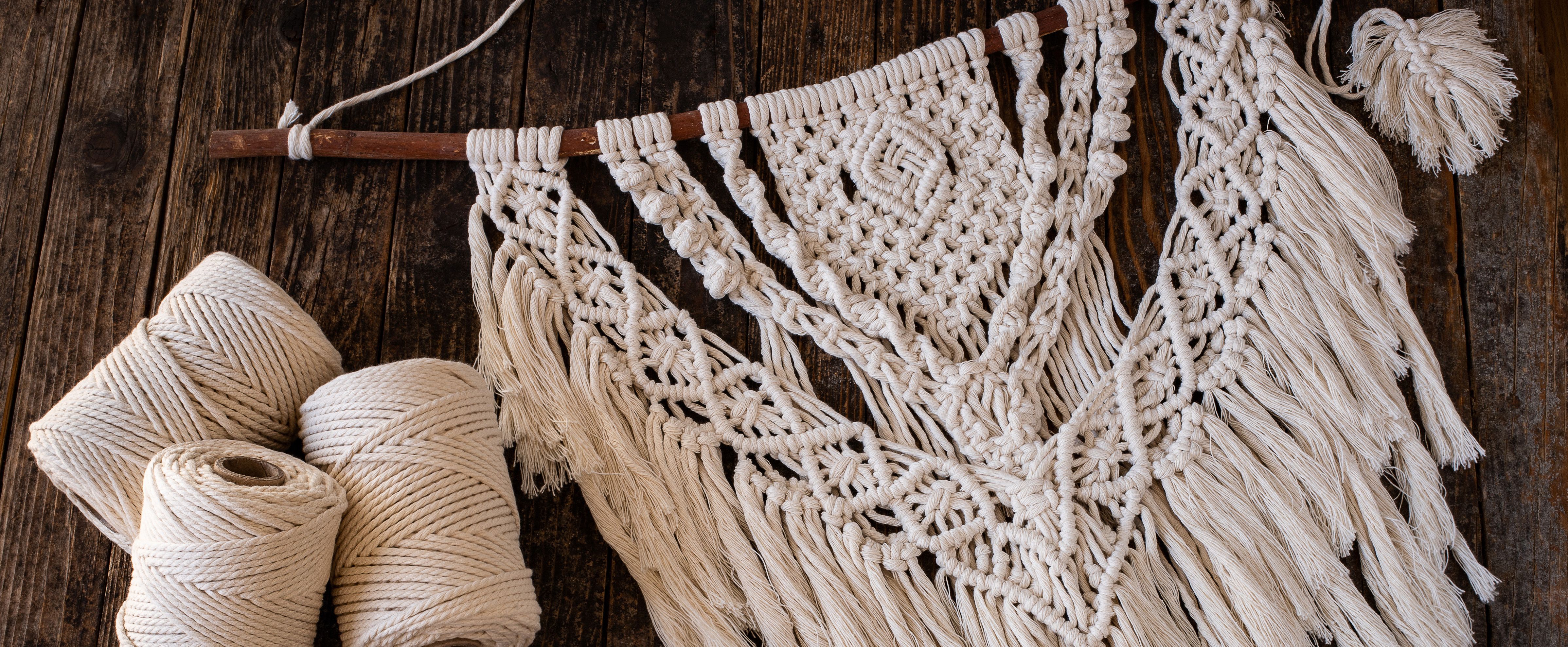 Arazzo da parete in macramè con corda naturale su legno, ideale per decorazioni fai da te per adulti.
