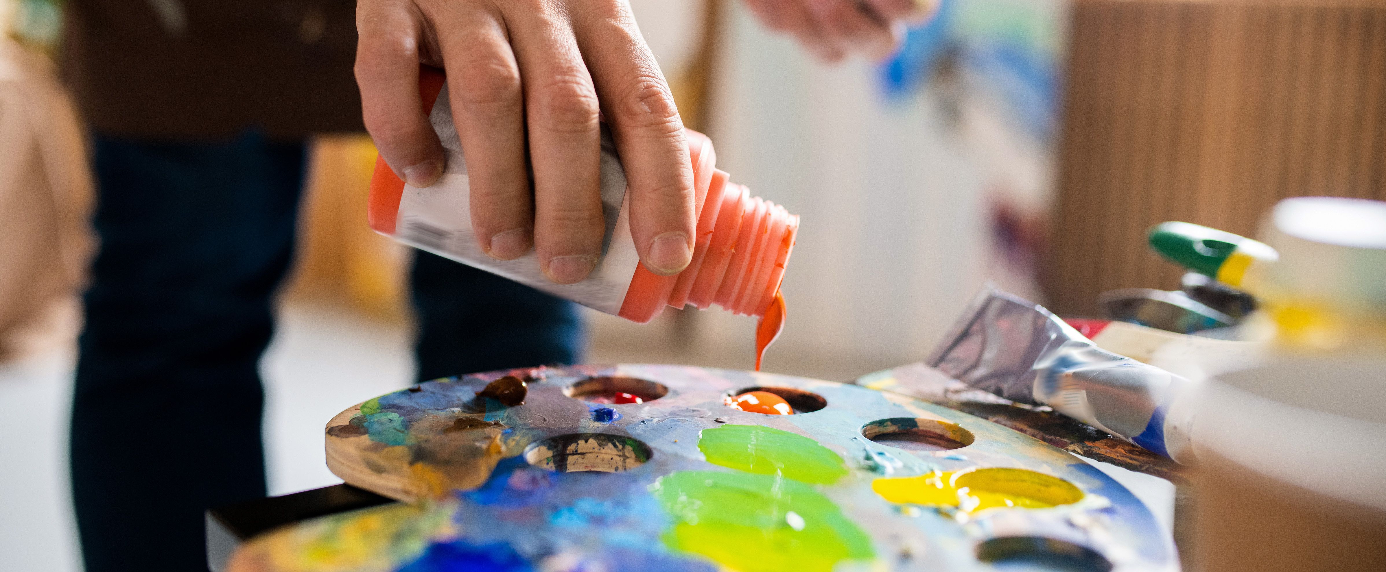 Applying acrylic paint to a palette for acrylic painting projects