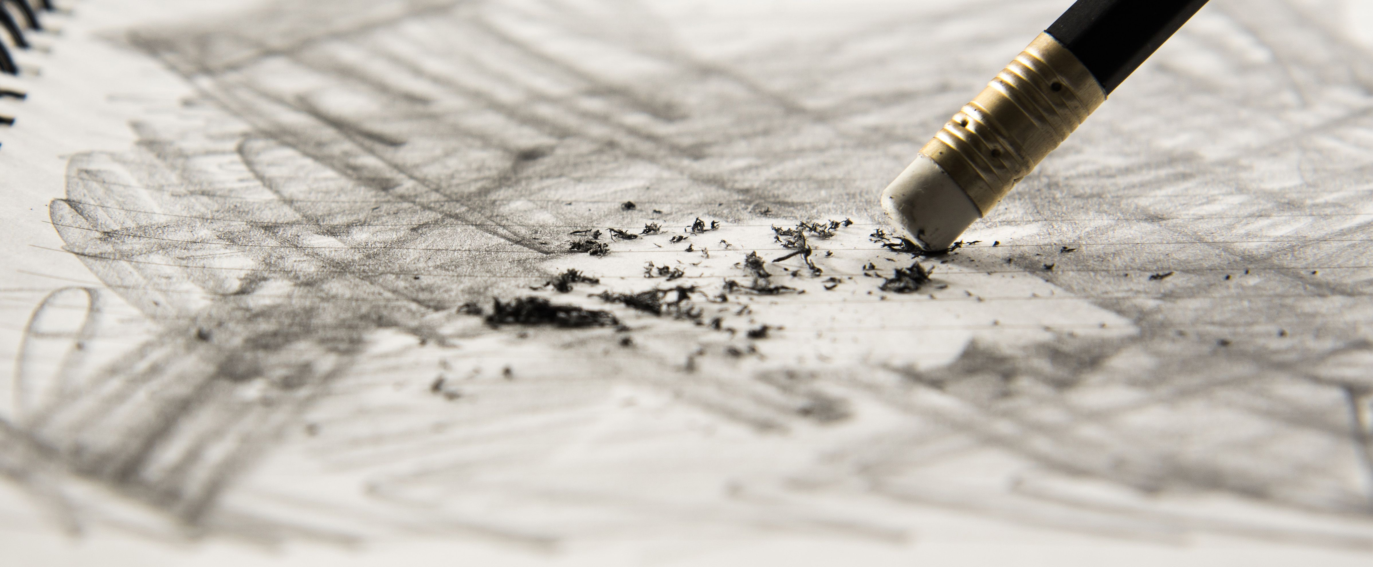 Erasing graphite on a pencil drawing with an eraser and pencil shavings