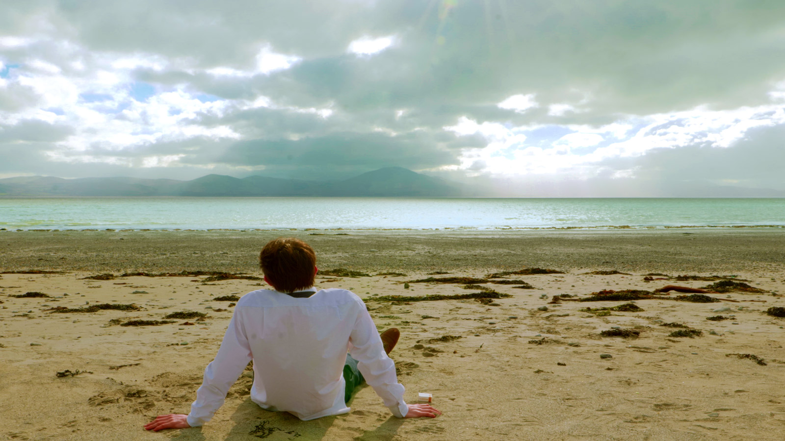 At the beach, Oscar finally parts with the remnants of his past and guilt. On the shore with the clouds parting the skies, he looks upon a new day for himself and a tomorrow he can look forward to again. Free from the “shadow” of sorrow he casted upon his memories of her.