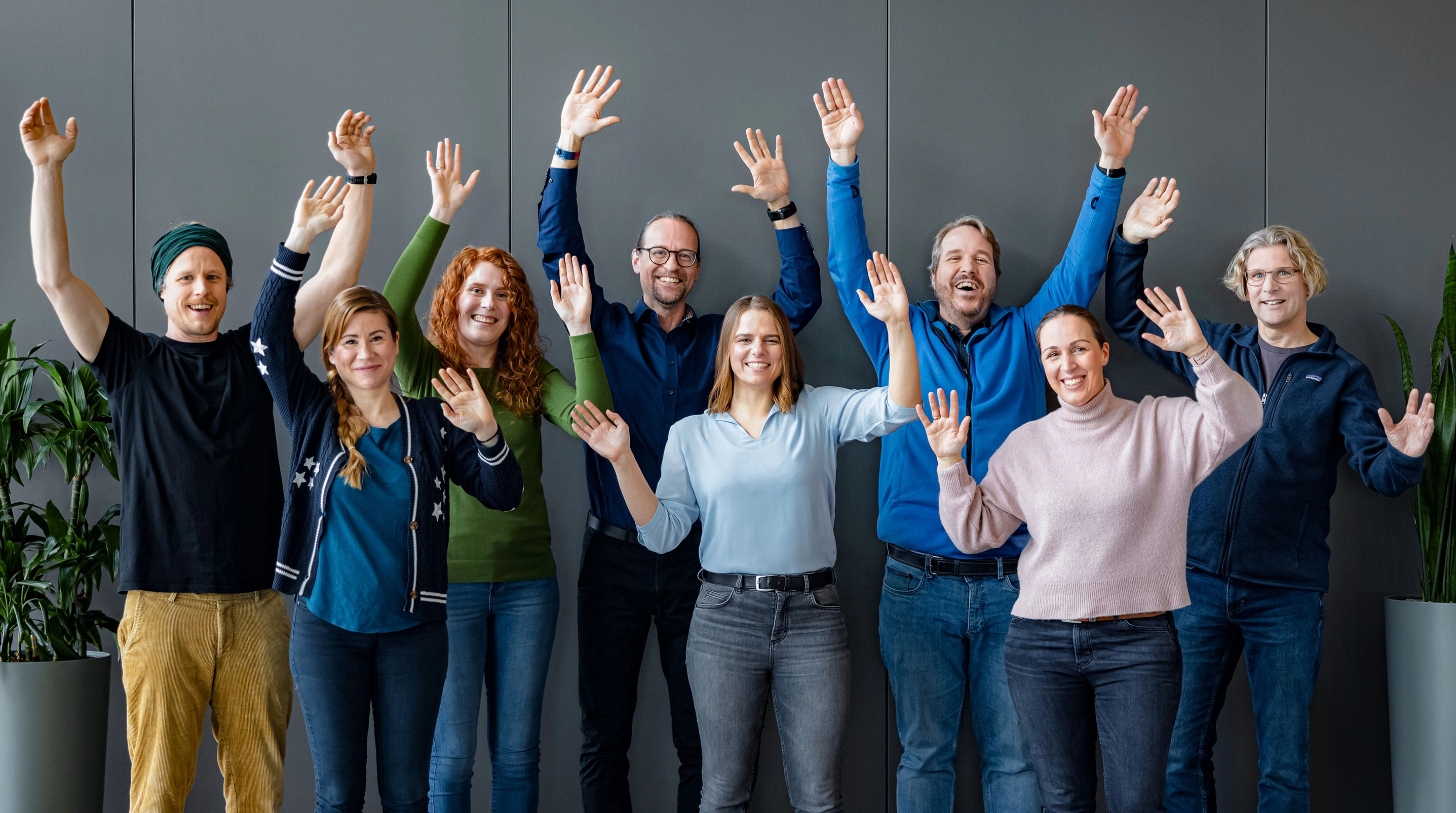Employees celebrate with raised hands