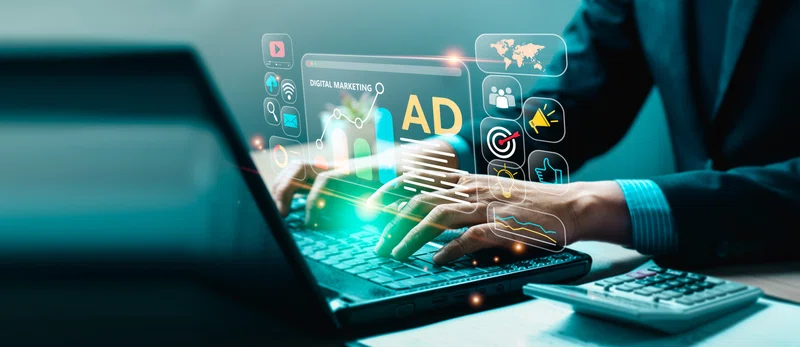 Man at keyboard creating an add