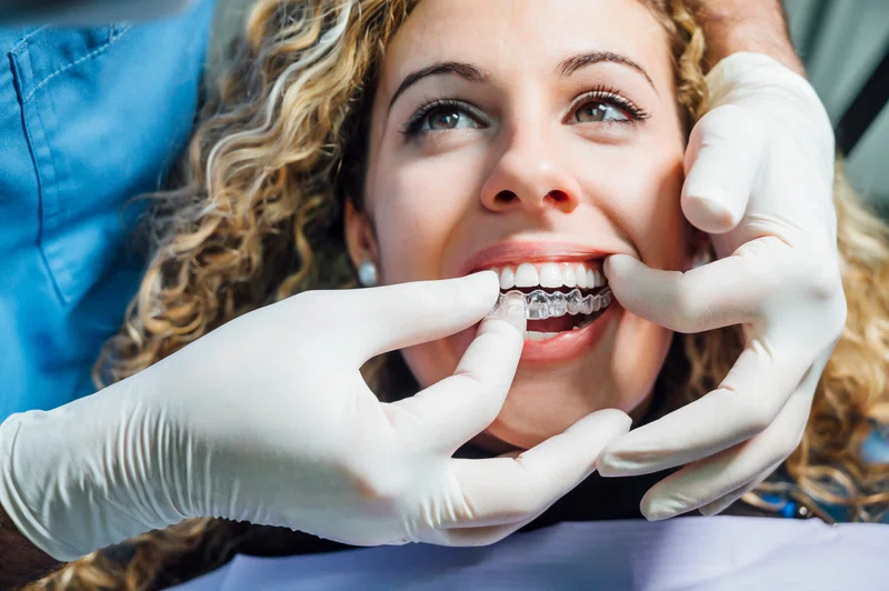 Woman getting fitted with Invisalign teeth straighter