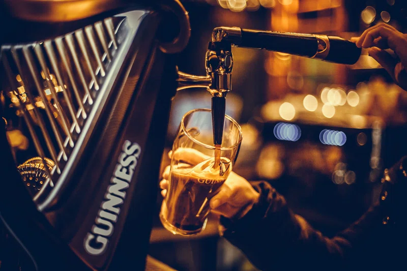 Barman pouring pint of Guinness