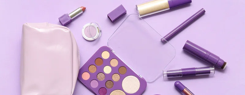 Selection of make up on a purple background