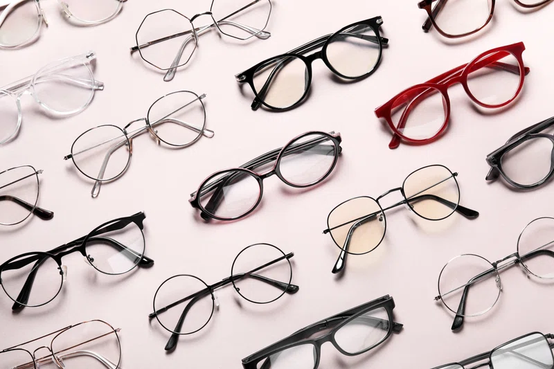 Stylish glasses on flat background