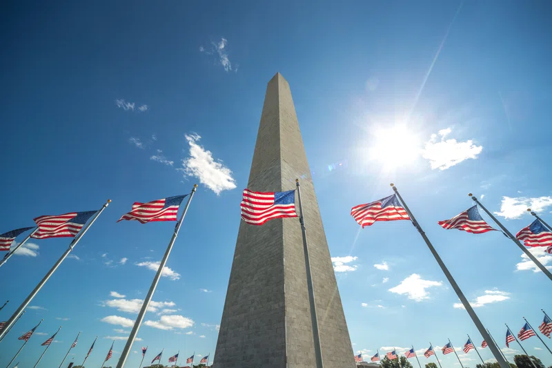 Washington Monument surrounded by stars and stripes flags