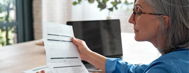 Older woman looking at document
