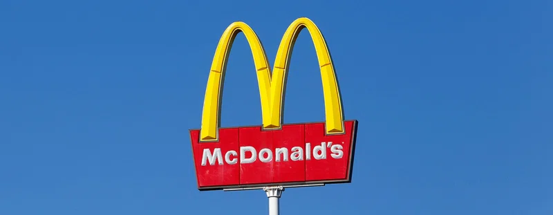 Mcdonalds sign against a blue sky