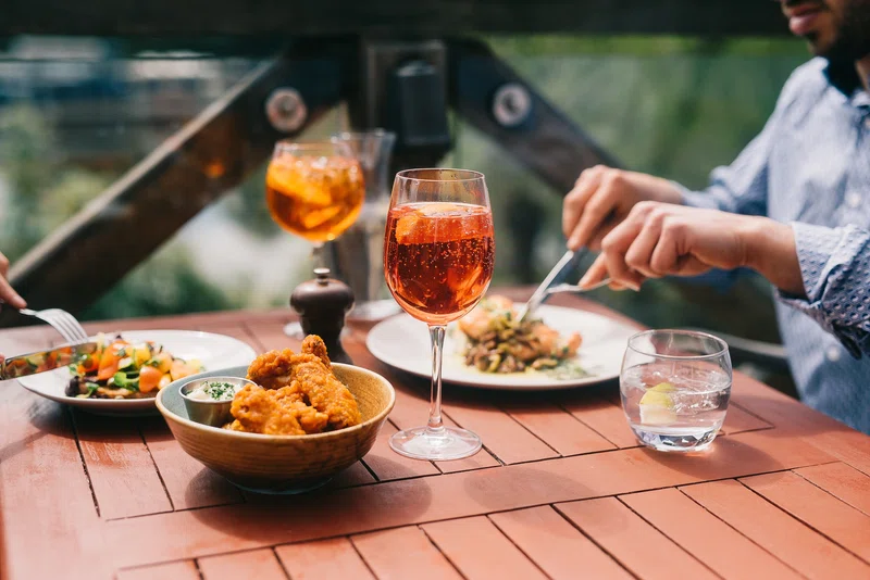 Couple enjoying drinks in pub garden