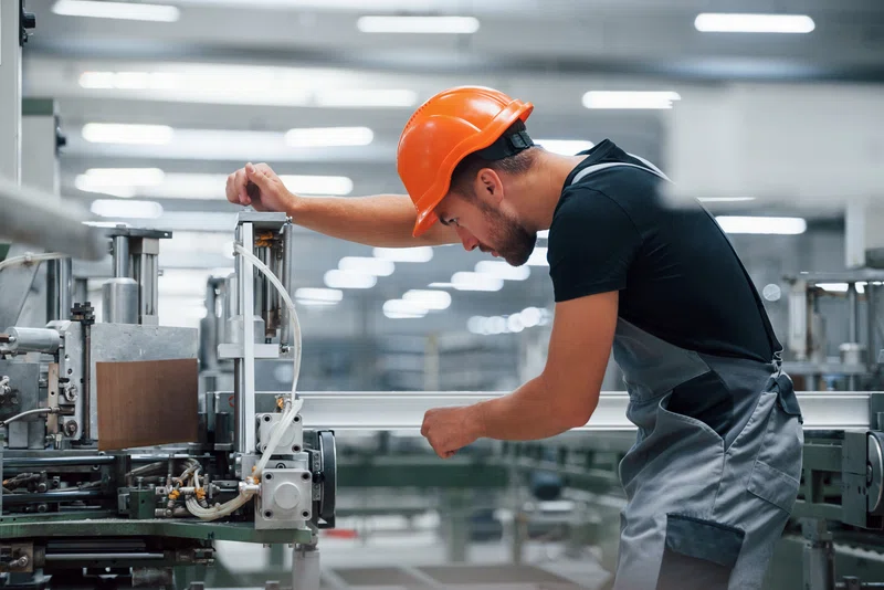 Picture of man in a hard hat working in a factory