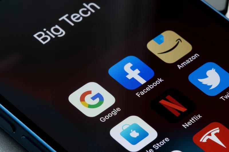Image of a smartphone with icons for major US technology firms displayed.