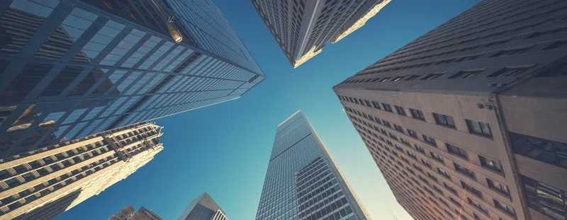 looking up at skyscrapers