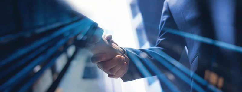 Businessmen shake hands on a merger