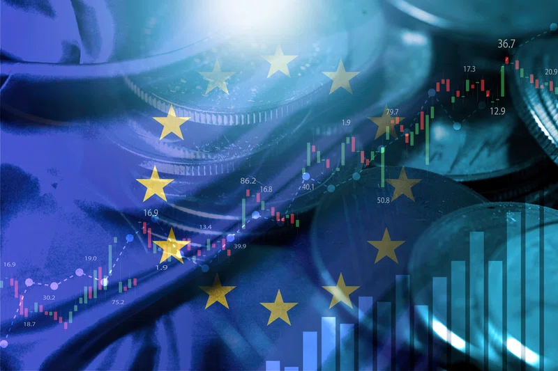 EU flag and coins with stock market chart