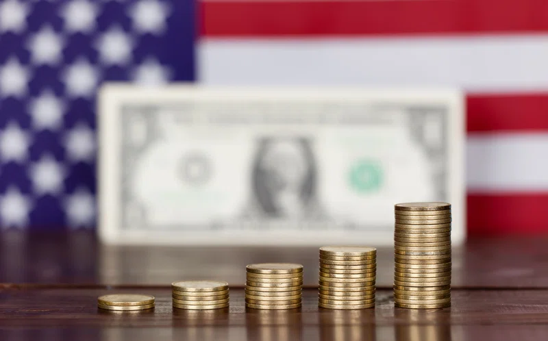 Coins, dollar bill and US flag