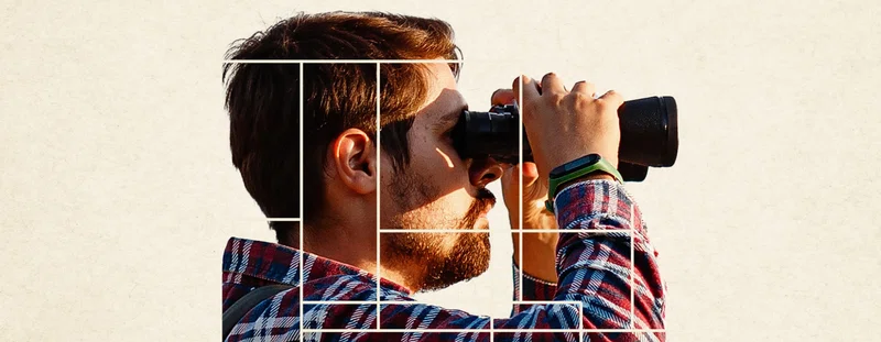 Man looking through binoculars
