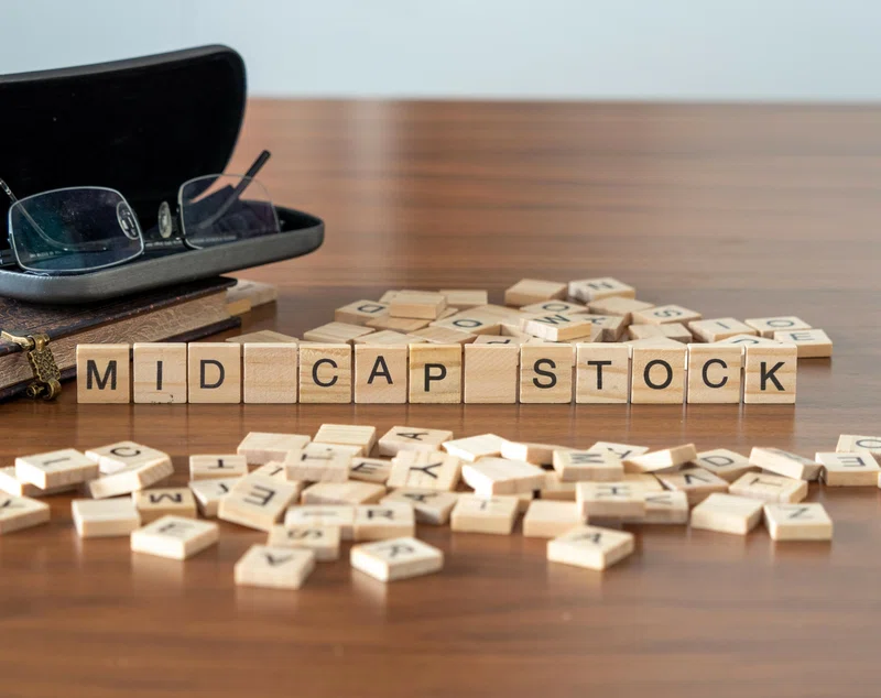 Mid cap stock words on wooden letter tiles
