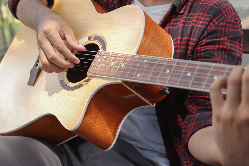 Man playing guitar in park