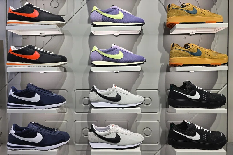 Nike sneakers on grid wall at JD Sports