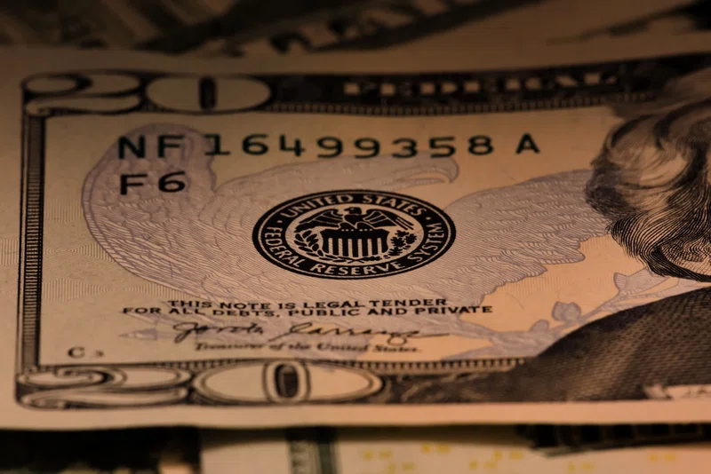 Dollar bill and Fed symbol