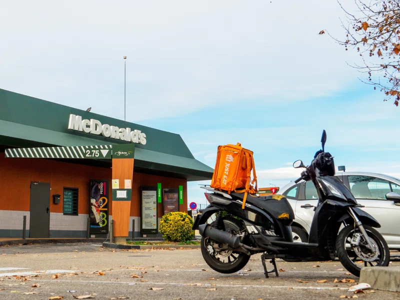 Just Eat motorcycle in front of McDonald's