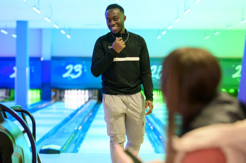 Man in tenpin bowling alley