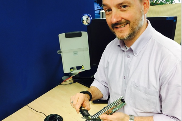picture of distribution engineering manager, Stefan Herchenreder at Accuride with a slide in his hands.