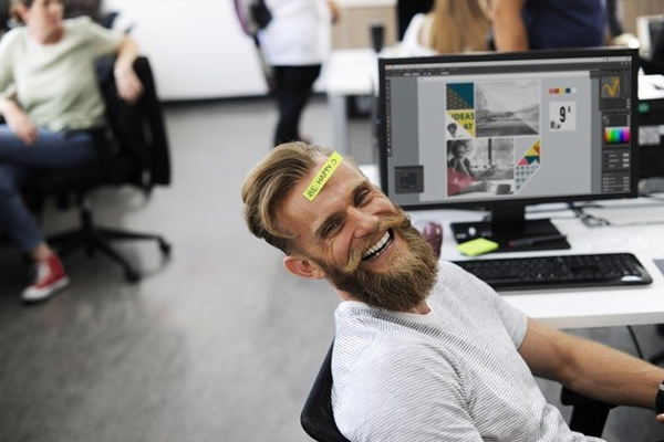 Happy-worker-in-open-plan-office-600x400.jpg