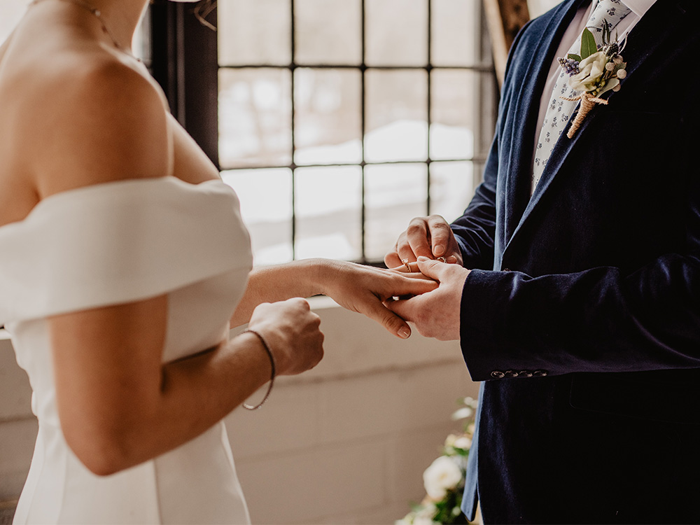 bride and groom exchange wedding rings