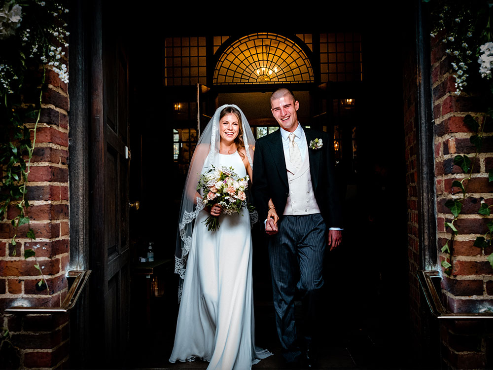 real sentimental wedding couple walk out hand in hand