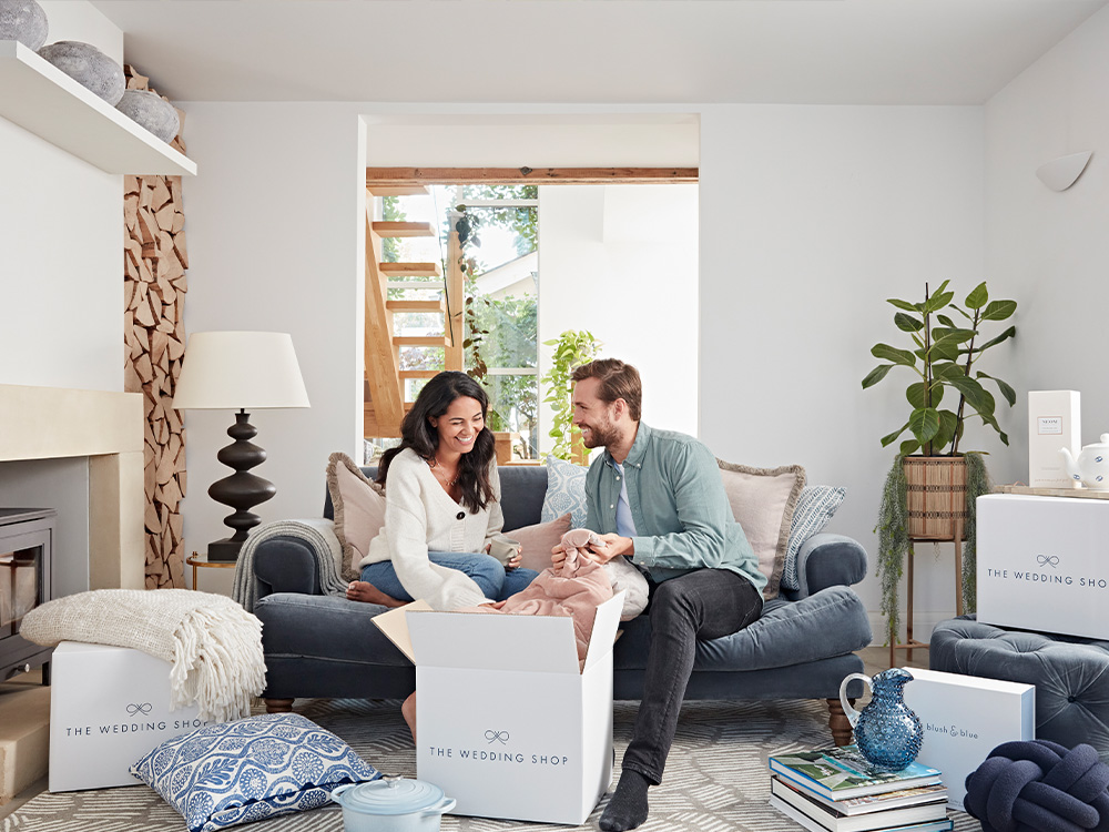 happy couple at home opening their wedding gifts