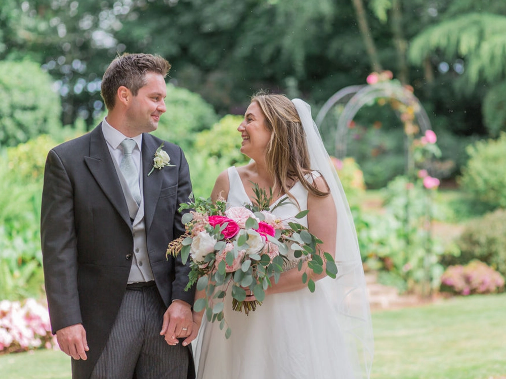 Bianca and Matt with wedding bouquet and hot pink flowers